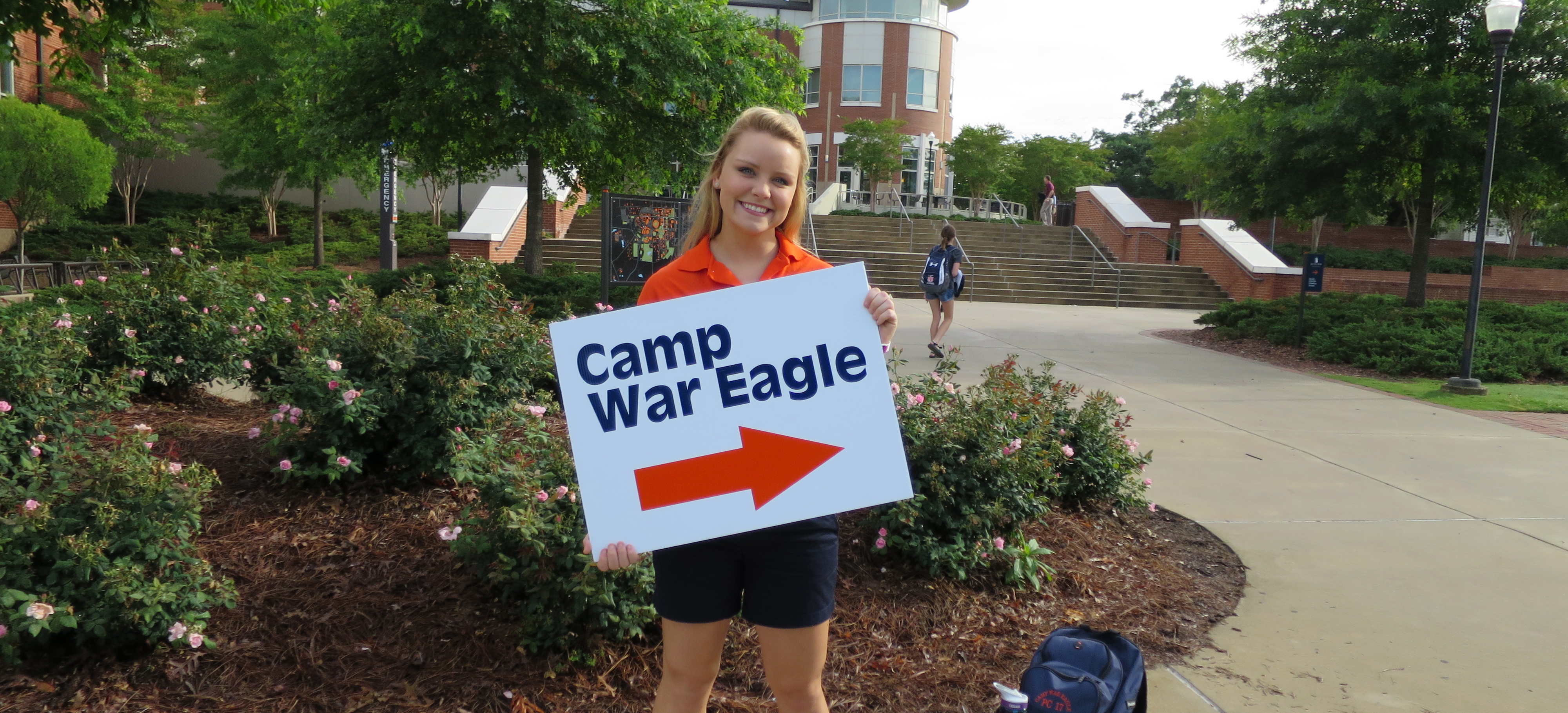Camp War Eagle Counselor holding sign